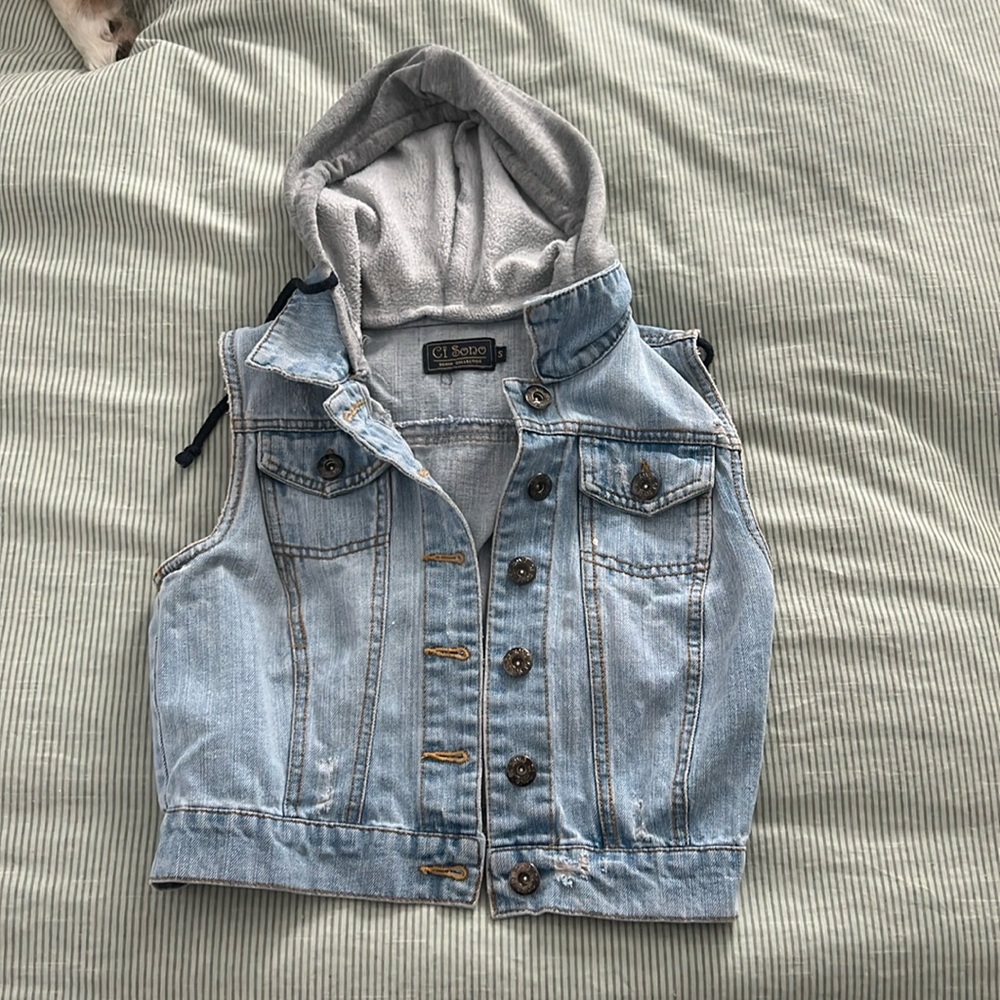 Light wash denim button down vest with grey sweatshirt hood